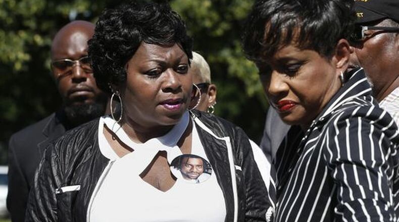 Judge Glenda Hatchett (right) escorts Valerie Castile, the mother of Philando Castile, off the platform after a news conference on the State Capitol grounds Tuesday in St. Paul, Minn. Hatchett, known for the TV show “Judge Hatchett” and her time as chief judge of the Juvenile Court of Fulton County in Atlanta, is representing the Castile family in the shooting death by police of Philando Castile last week in Falcon Heights, Minn., after a traffic stop. JIM MONE / AP