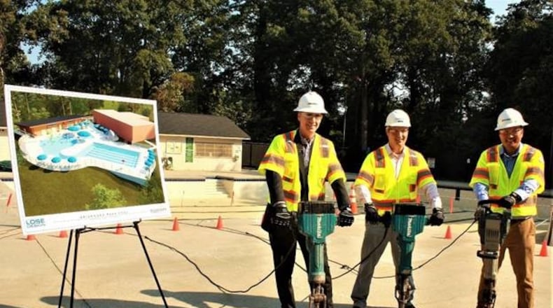 Brookhaven Councilman Bates Mattison (left), Mayor John Ernst and Councilman John Park "crack" ground at Brookhaven's Briarwood Park pool.