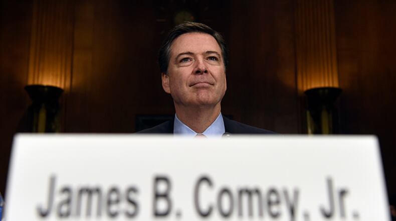In this Dec. 9, 2015 file photo, FBI Director James Comey prepares to testify on Capitol Hill in Washington. Comey's announcement that his bureau was reviewing new emails possibly relevant to Hillary Clinton's private email server investigation has thrust him into the public spotlight again just days before Election Day.