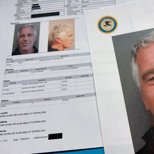 FILE - Documents that were included in the U.S. Department of Justice release of the Jeffrey Epstein files are photographed Friday, Jan. 2, 2026. (AP Photo/Jon Elswick, File)