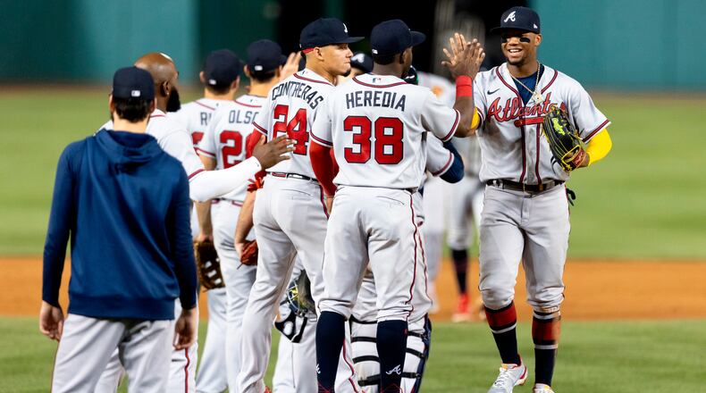 Ronald Acuña celebrates with teammates after Tuesday's victory over the Washington Nationals, the 13th straight win for the Braves. The team's win streak is now 14 as it prepares for Friday's game in Chicago against the Cubs. (AP Photo/Julia Nikhinson)