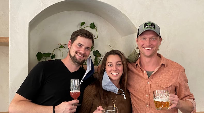 Elsewhere Brewing Co.’s Director of Brewing Operations Josh Watterson (left) and co-founders Sara and Sam Kazmer are at the taproom in Grant Park. (Bob Townsend for The Atlanta Journal-Constitution)