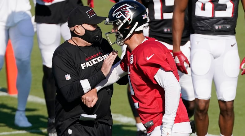 Atlanta Falcons coach Dan Quinn and quarterback Matt Ryan speak during an NFL football practice Tuesday, Aug. 18, 2020, in Flowery Branch, Ga. (AP Photo/John Bazemore, Pool)