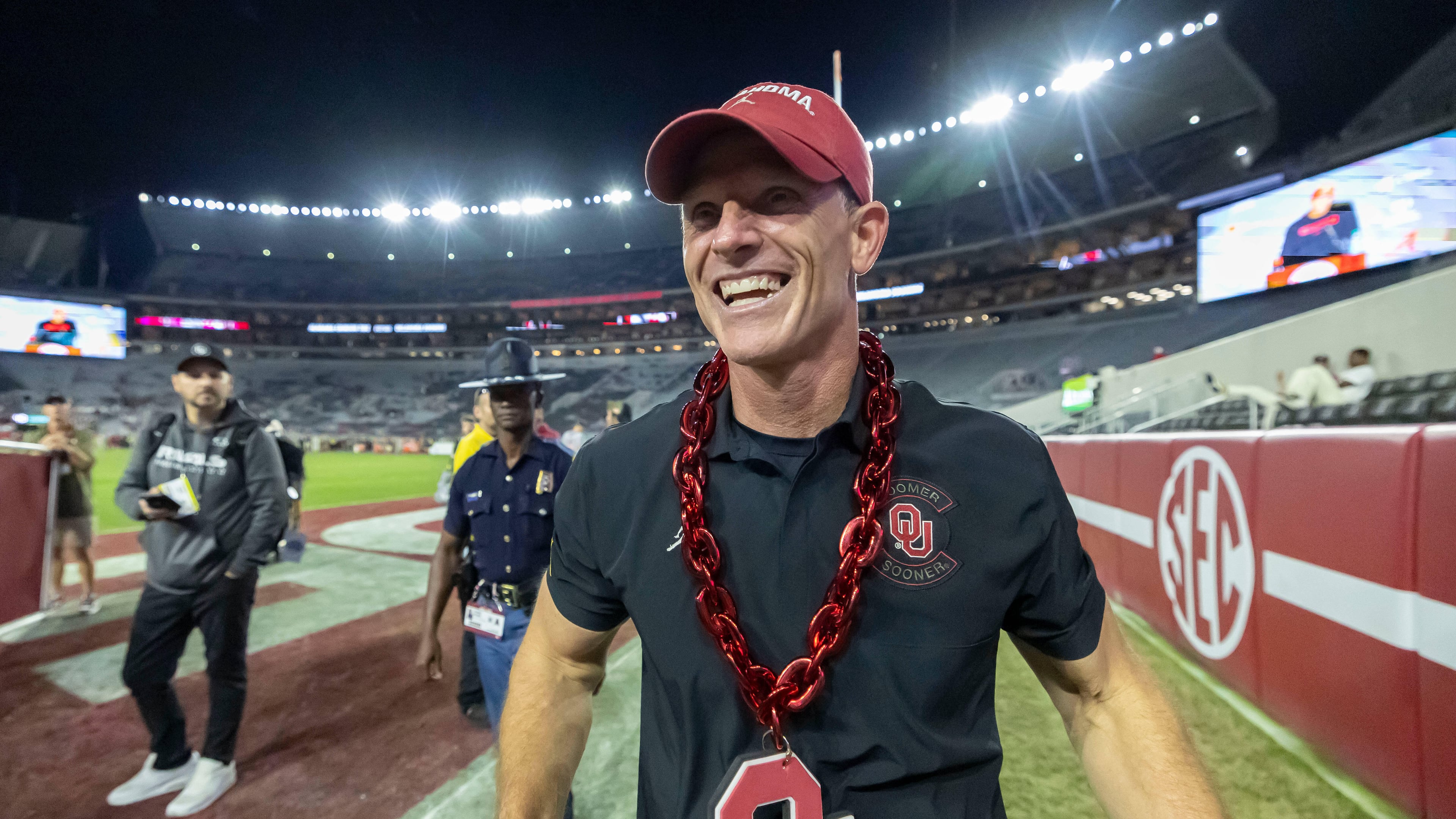 Oklahoma head coach Brent Venables wears an Oklahoma chain given to him postgame by a fan as he walks into the locker room after defeating Alabama at an NCAA college football game, Saturday, Nov. 15, 2025, in Tuscaloosa, Ala. (AP Photo/Vasha Hunt)