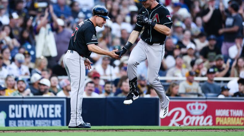 Arizona Diamondbacks' Max Kepler, right, is congratulated by third base coach J.R. House, left, after hitting a three-run home run against the San Diego Padres in the third inning of a baseball game Monday, July 6, 2026, in San Diego. (AP Photo/Derrick Tuskan)