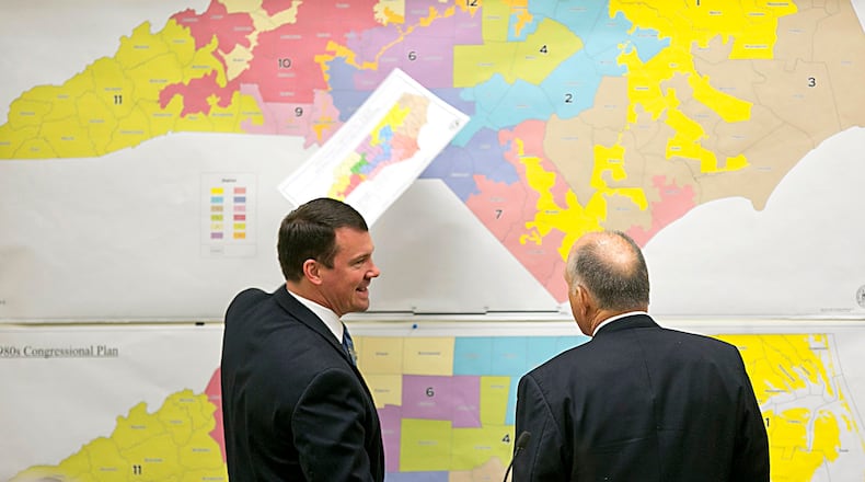 In this 2016 file photo, Republican state Sens. Dan Soucek, left, and Brent Jackson, right, review historical North Carolina maps. Corey Lowenstein/The News & Observer, via AP