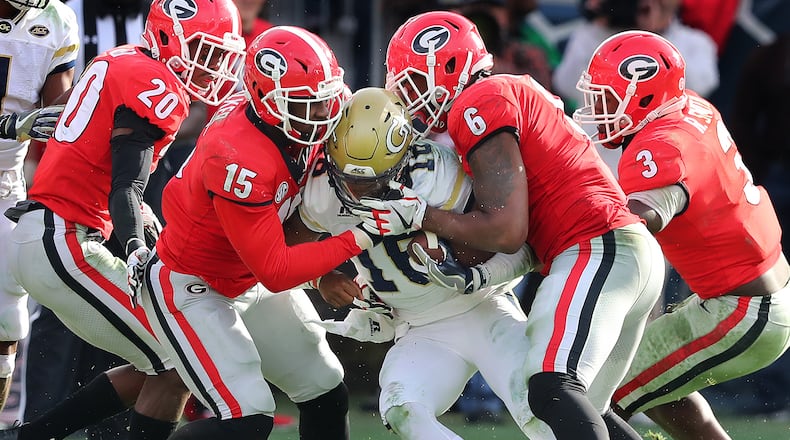 Georgia linebacker Natrez Patrick (6), showing here with defenders J.R. Reed (from left), D’Andre Walker and Roquan Smith, swarm Georgia Tech quarterback TaQuon Marshall during the second half of a game last month.