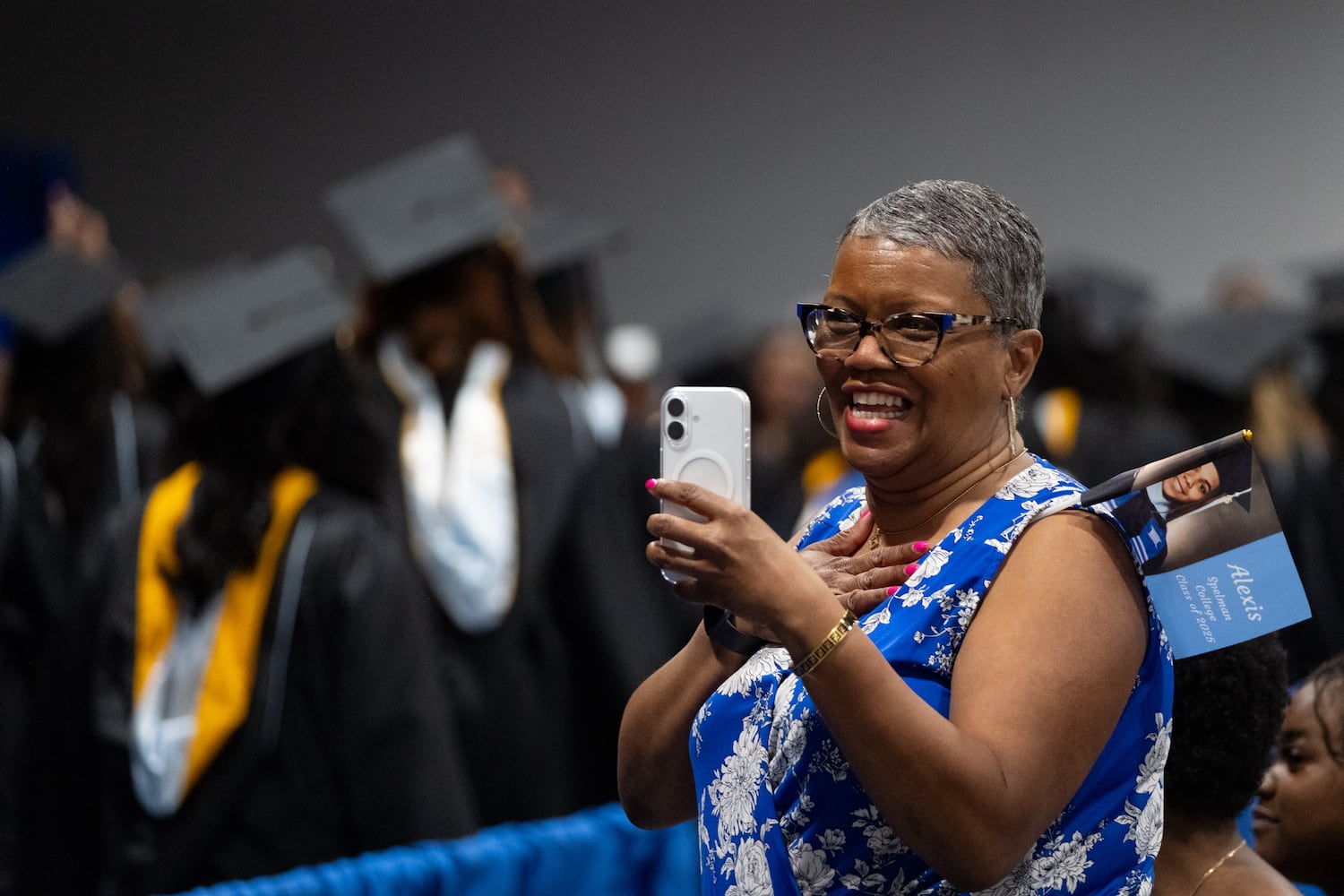 Gina Lamar looks for her great niece Alexis Harvey as graduates process in for the Spelman College graduation ceremony at the Georgia International Convention Center in College Park on Sunday, May 18, 2025.   Ben Gray for the Atlanta Journal-Constitution