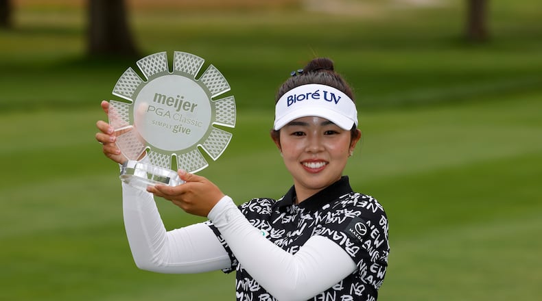 Miyu Yamashita, of Japan, holds her trophy after winning the Meijer LPGA Classic golf tournament, Sunday, June 21, 2026, in Belmont, Mich. (AP Photo/Al Goldis)