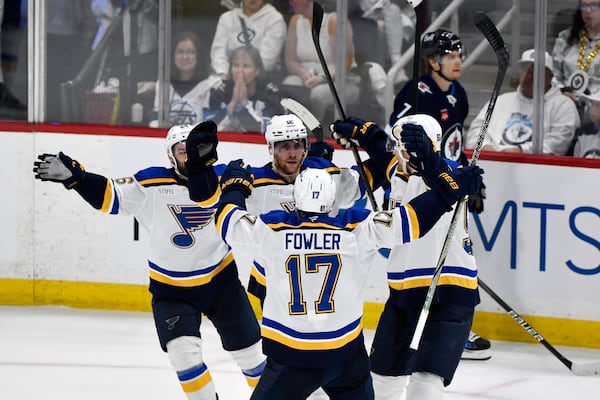 St. Louis Blues' Radek Faksa (12) celebrates after his goal against the Winnipeg Jets with Cam Fowler (17) during the second period of Game 7 in an NHL hockey first-round playoff series in Winnipeg, Manitoba, Sunday, May 4, 2025. (Fred Greenslade/The Canadian Press via AP)