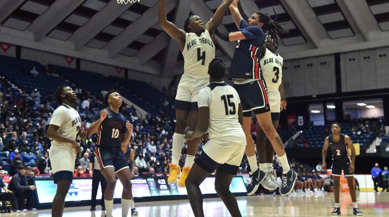 March 12, 2022 Macon - Berkmar's Malique Ewin (21) shoots over Norcross' Samarion Bond (4) during the 2022 GHSA State Basketball Class AAAAAAA Boys Championship game at the Macon Centreplex in Macon on Saturday, March 12, 2022. Norcross won 58-45 over Berkmar. (Hyosub Shin / Hyosub.Shin@ajc.com)