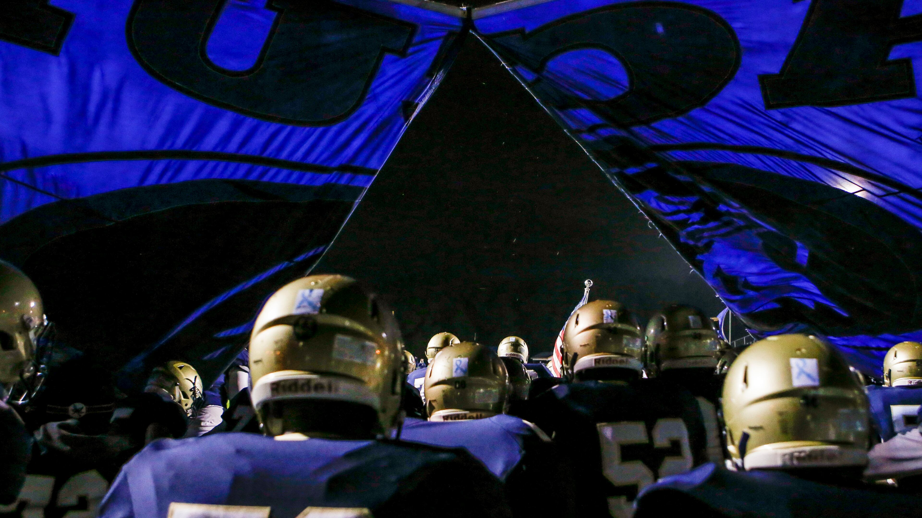 The Dacula football team breaks through their banner as they run onto the field before a game against Lanier Friday, Oct. 26, 2018, at Dacula High School in Dacula.