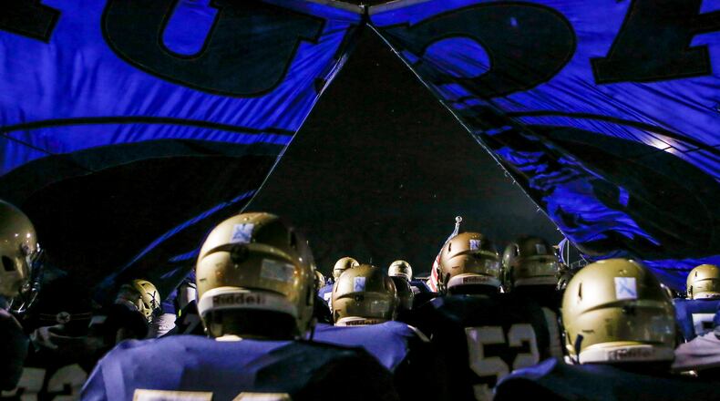 The Dacula football team breaks through their banner as they run onto the field before a game against Lanier Friday, Oct. 26, 2018, at Dacula High School in Dacula.