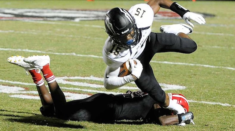 Mountain View WR Malachi Carter (15) gets tripped up by North Gwinnett DE Dixon Yellott during the first half of Friday's game. (John Amis/Special)