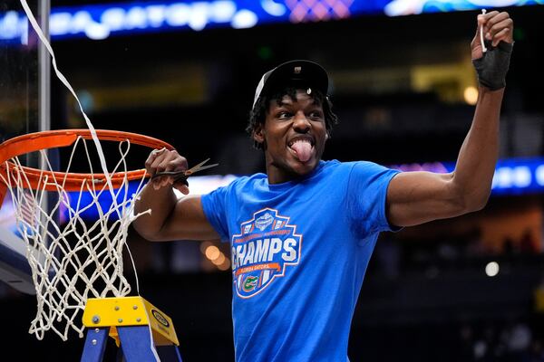 Florida center Rueben Chinyelu (9) cunte part of the net to celebrate victory over Tennessee after an NCAA college basketball game in the final round of the Southeastern Conference tournament, Sunday, March 16, 2025, in Nashville, Tenn. (AP Photo/George Walker IV)