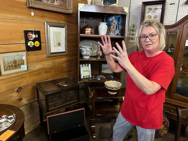 Michelle Hackworth discusses U.S. politics standing in her Paintsville, Ky., antiques store, Friday, May 16, 2025. (AP Photo/Bill Barrow)