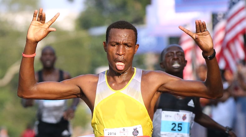 Gabriel Geay (front to back) wins the three-way race to the finish line, beating Daniel Salel and Philip Langat to win the 47th running of the AJC Peachtree Road Race at Piedmont Park on Monday, July 4, 2016, in Atlanta. Curtis Compton / ccompton@ajc.com