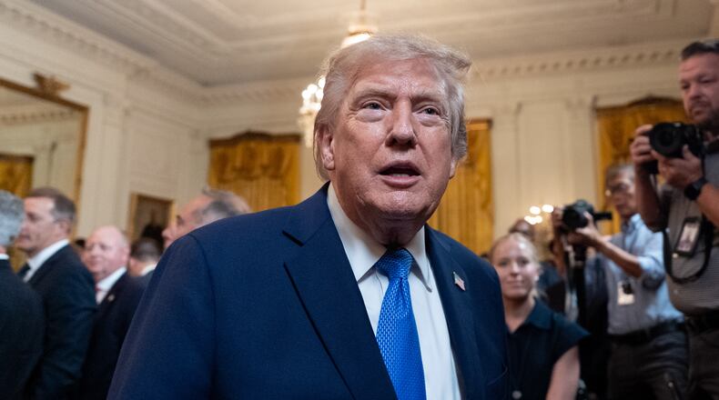 President Donald Trump speaks with a reporter as he departs after an event for Olympic athletes, coaches, staff, and representatives from Team USA in the East Room of the White House, Thursday, Aug. 6, 2026, in Washington. (AP Photo/Alex Brandon)