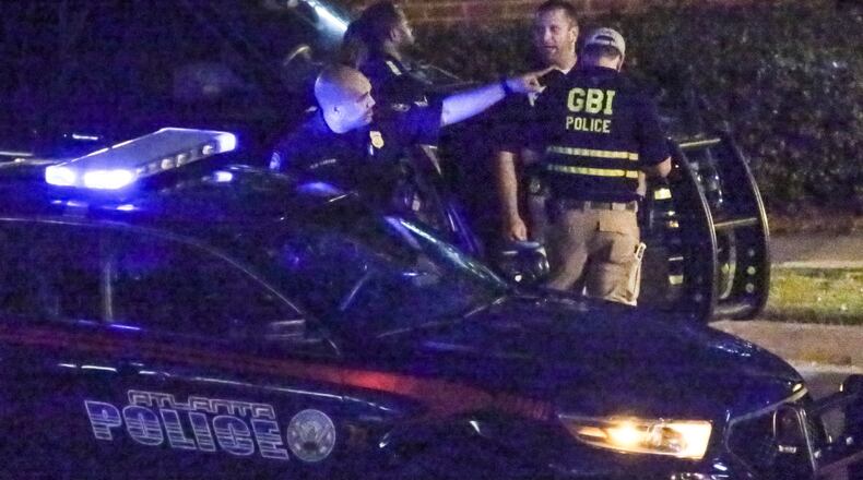 GBI investigators examine the scene where Atlanta Police Officer James Burns shot and killed teenager Deravis Caine Rogers in June 2016. JOHN SPINK /JSPINK@AJC.COM