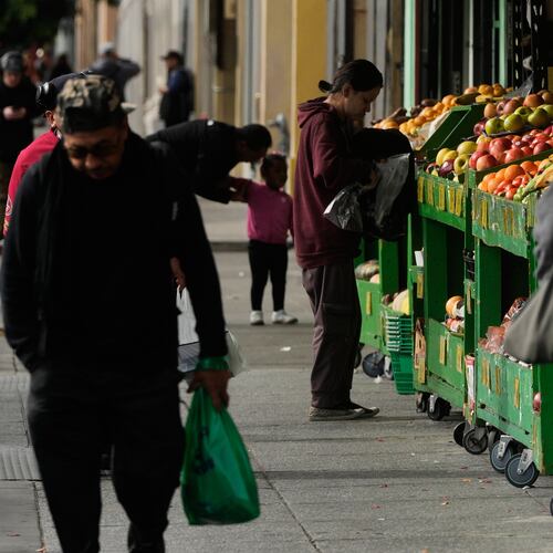 A person shops for produce at a market in San Francisco on Saturday, Nov. 15, 2025. (AP Photo/Jeff Chiu)