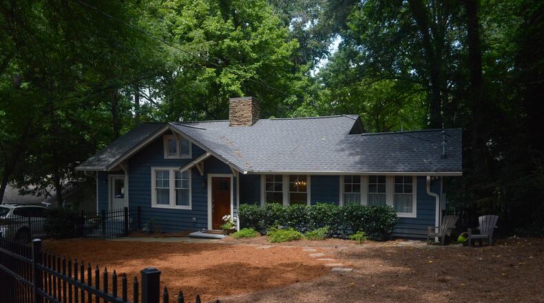Aaron and Amanda Clark bought their 1928 Craftsman cottage in Peachtree Hills in 2013. The house is painted Sherwin-Williams Grays Harbor with Sherwin-Williams Moderate White trim and features a Craftsman-style mahogany front door with an espresso and Jacobean stain.