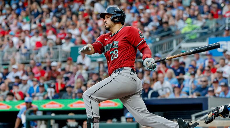 Arizona Diamondbacks third baseman Nolan Arenado (28) follows through on an RBI grounder against the Atlanta Braves during the second inning of a baseball game, Saturday, August 15, 2026, in Atlanta. (AP Photo/Erik S. Lesser)