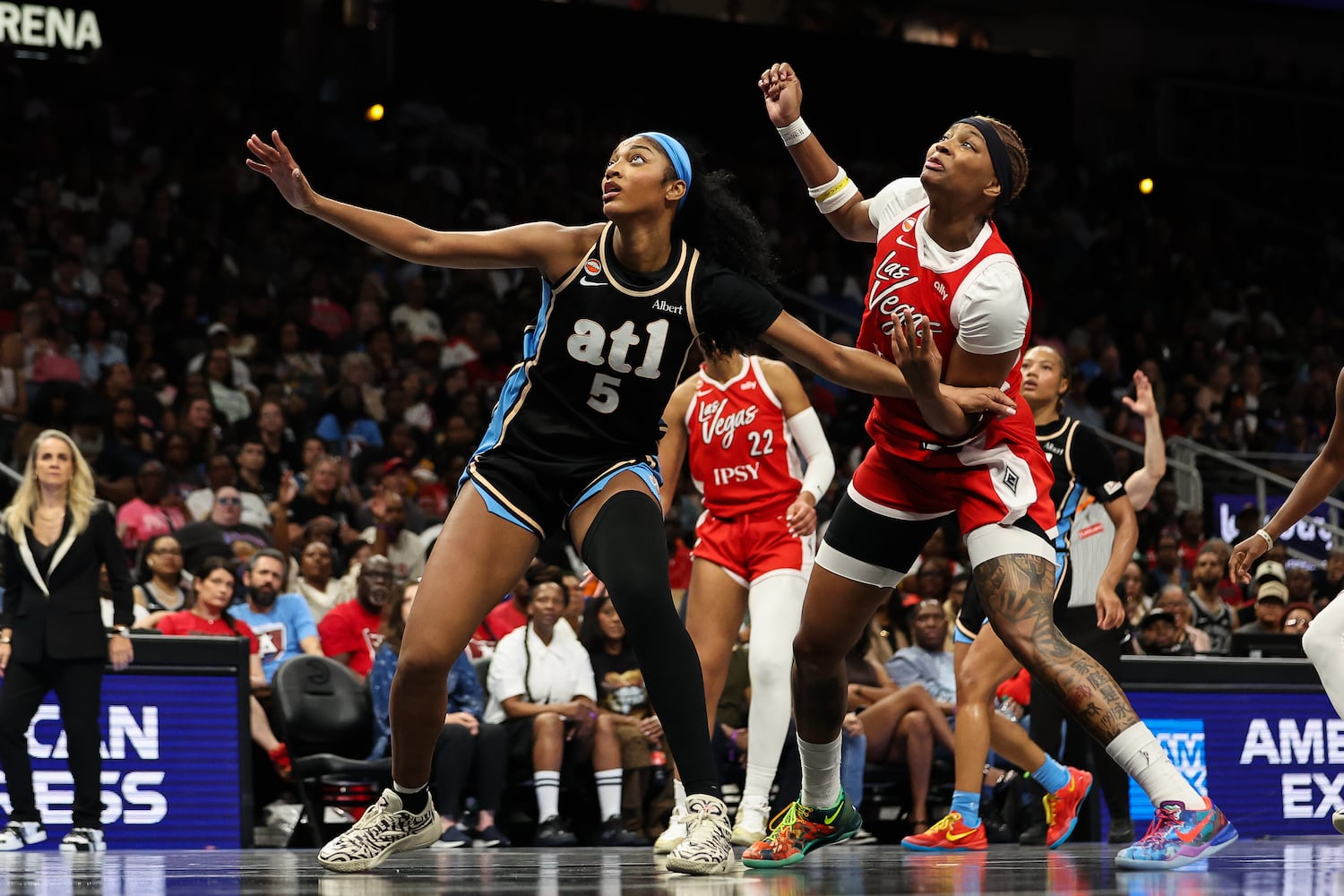 Dream forward Angel Reese (left) fights for a rebound against Aces forward NaLyssa Smith on Sunday, May 17, 2026, at State Farm Arena in Atlanta. (Colin Hubbard for the AJC) 