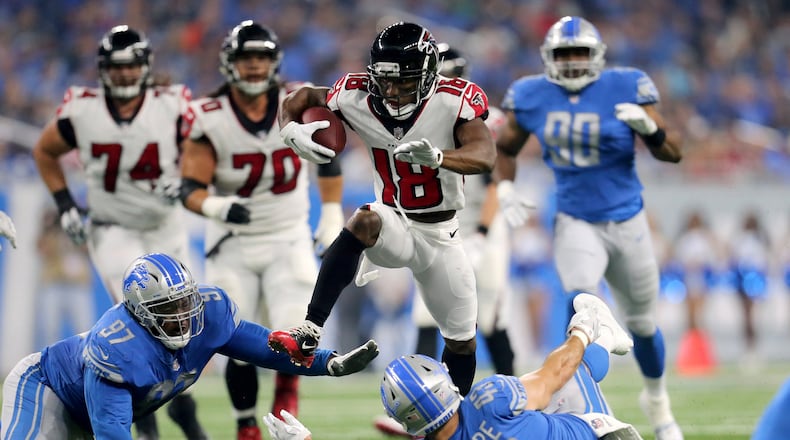 Falcons wide receiver Taylor Gabriel hurdles Armonty Bryant Lions and Nick Bellore (#43) during the first quarter at Ford Field on September 24 in Detroit, Michigan.