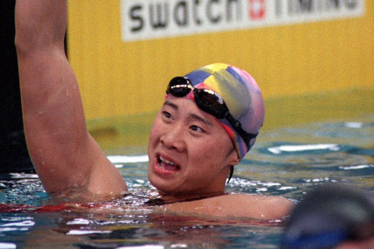 Chinese swimmer Le Jingyi celebrates her victory in the 100 meter freestyle competition at the Georgia Tech Aquatic Center during the 1996 Summer Olympic Games in Atlanta. (David Tuilis/AJC)