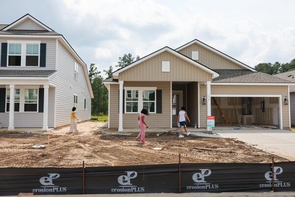 People tour a home at Beacon Point at New Hampstead in Savannah on Saturday, Aug. 1, 2026. (Arvin Temkar/AJC)
