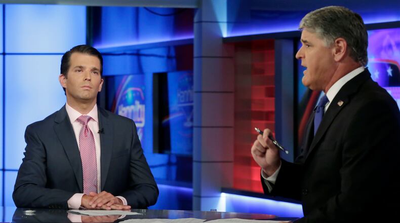 Donald Trump Jr., left, is interviewed by host Sean Hannity on his Fox News Channel television program, in New York Tuesday, July 11, 2017. Donald Trump Jr. eagerly accepted help from what was described to him as a Russian government effort to aid his father's campaign with damaging information about Hillary Clinton, according to emails he released publicly on Tuesday. (AP Photo/Richard Drew)