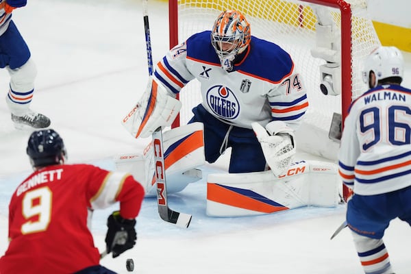 Edmonton Oilers goalie Stuart Skinner (74) stops Florida Panthers' Sam Bennett (9) during the second period in Game 6 of the Stanley Cup final in Sunrise, Fla., on Tuesday, June 17, 2025. (Nathan Denette/The Canadian Press via AP)