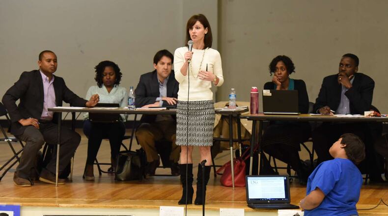Kathleen Mathers (center), Latin Academy board member, speaks during a meeting earlier this year. HYOSUB SHIN / HSHIN@AJC.COM