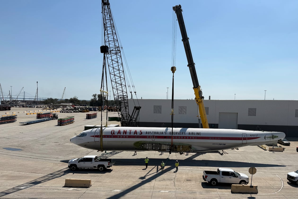 Cranes lift the fuselage of a Boeing 707 once owned by movie actor John Travolta and music icon Frank Sinatra. The aircraft was trucked last month from Brunswick Golden Isles Airport to the Georgia Ports Authority's Colonels Island Terminal ahead of it being shipped by cargo vessel to Australia, where it will be displayed at an aviation museum. (Courtesy of Wallenius Wilhelmsen)