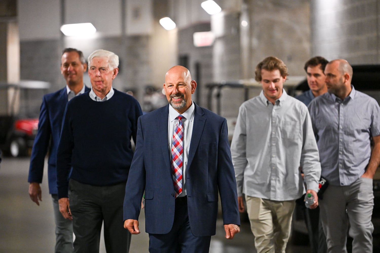 Newly hired Braves manager Walt Weiss (center) walks with President and CEO Derek Schiller (from left) and MLB Chairman Terry McGuirk, along with his sons Brody and Blake Weiss, to a news conference Tuesday, Nov. 4, 2025, at Truist Park in Atlanta. (Daniel Varnado for the AJC)