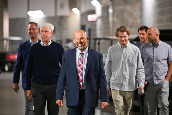 Newly hired Braves manager Walt Weiss (center) enters Truist Park with President and CEO Derrick Schiller (from left), MLB Chairman Terry McGuirk, and sons Brody and Blake Weiss (far right) prior to a news conference Tuesday. (Daniel Varnado for the AJC)