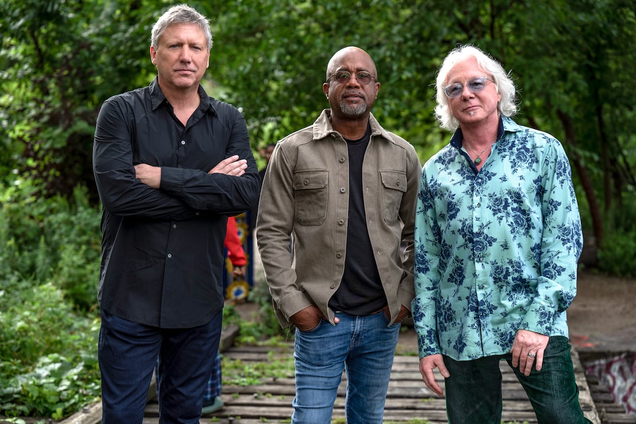 R.E.M.'s Mike Mills (right) says of Howl Owl Howl, the new band with friends (from left) Steve Gorman of the Black Crowes and Darius Rucker of Hootie and the Blowfish, "I believe the crowd expects us to be good, even though they may not know exactly what they’re gonna get before they hear it." (Courtesy of Steven Cohen Photo)