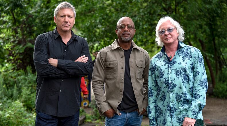 R.E.M.'s Mike Mills (right) says of Howl Owl Howl, the new band with friends (from left) Steve Gorman of the Black Crowes and Darius Rucker of Hootie and the Blowfish, "I believe the crowd expects us to be good, even though they may not know exactly what they’re gonna get before they hear it." (Courtesy of Steven Cohen Photo)