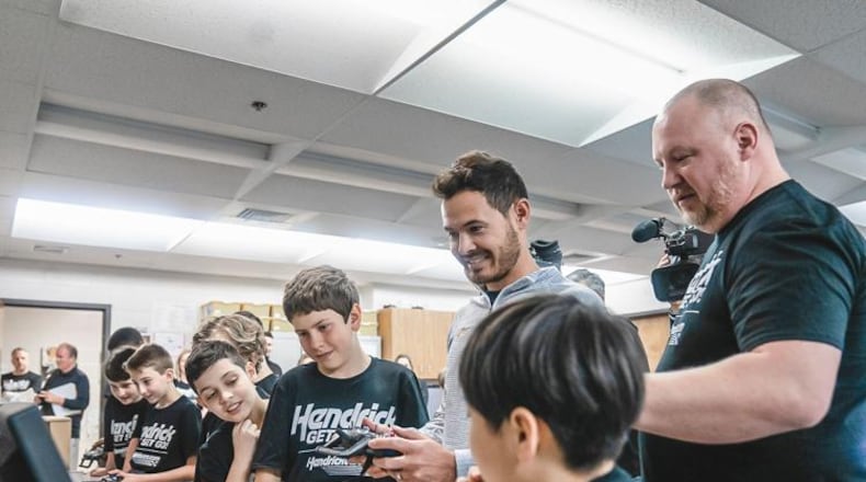 NASCAR Cup Series champion Kyle Larson smiles as he tours a STEM classroom at Harmony Elementary in Buford. (Courtesy of Sheer+Candid)