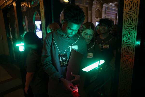 Students from Putnam County High School and Pebblebrook High School scan tickets during a shadowing day at the Fox Theatre in Atlanta on Monday, March 23, 2026. (Arvin Temkar/AJC)