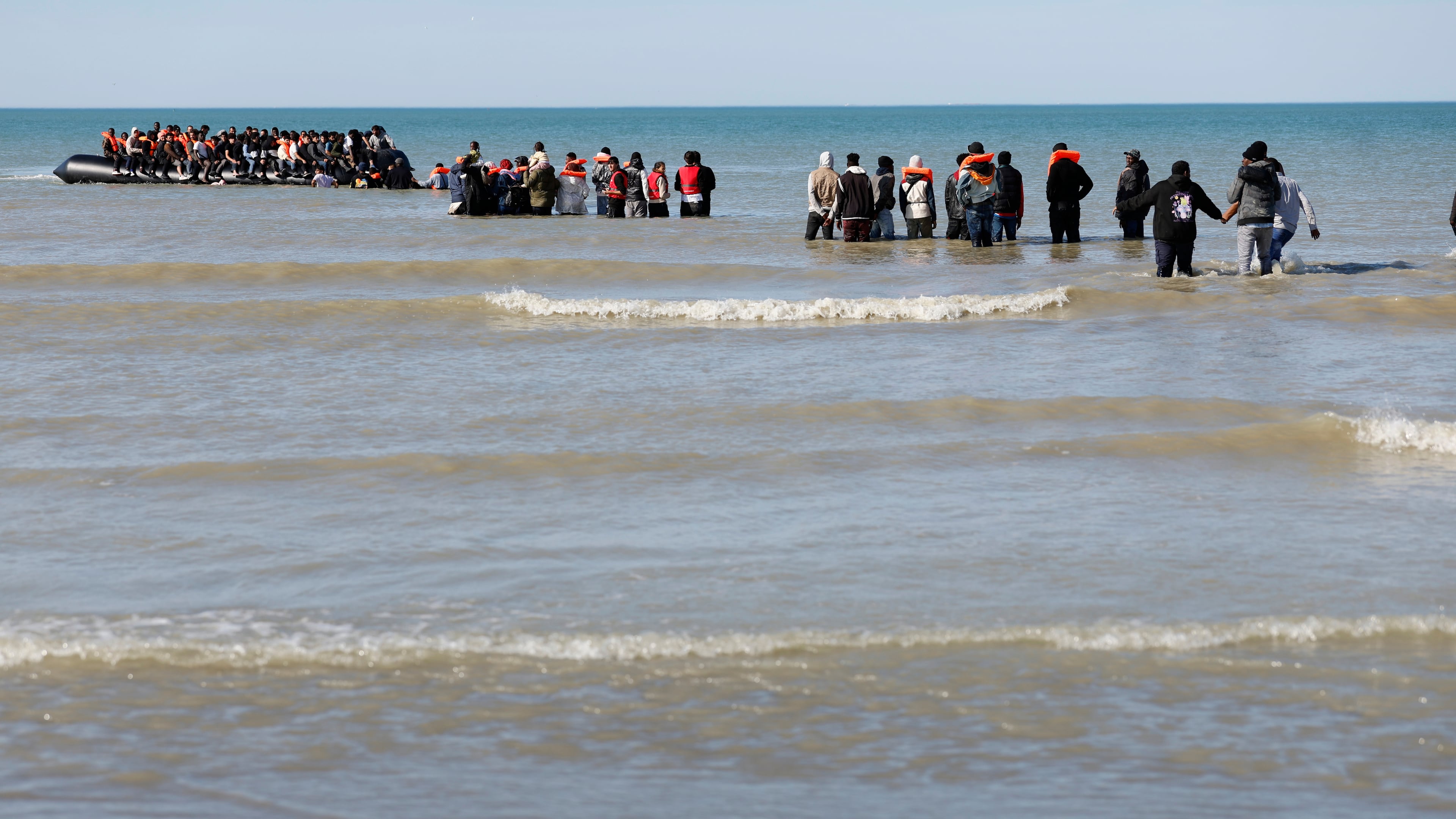 Migrants board a small boat to reach Britain, in Gravelines, northern France, France, Friday, Sept. 19, 2025. (AP Photo/Jean-Francois Badias)