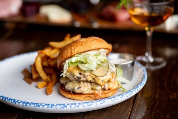 BE Burger, a double stack with Muenster cheese, house pickles, mayo, lettuce, and hand cut fries. Photo credit- Mia Yakel