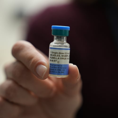 FILE - Dr. Jessica Early holds a vial of the combination measles, mumps and rubella vaccine at Prisma Health Pediatrics in Greer, S.C., March 18, 2026. (AP Photo/Mary Conlon, File)