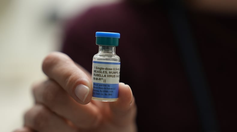 FILE - Dr. Jessica Early holds a vial of the combination measles, mumps and rubella vaccine at Prisma Health Pediatrics in Greer, S.C., March 18, 2026. (AP Photo/Mary Conlon, File)
