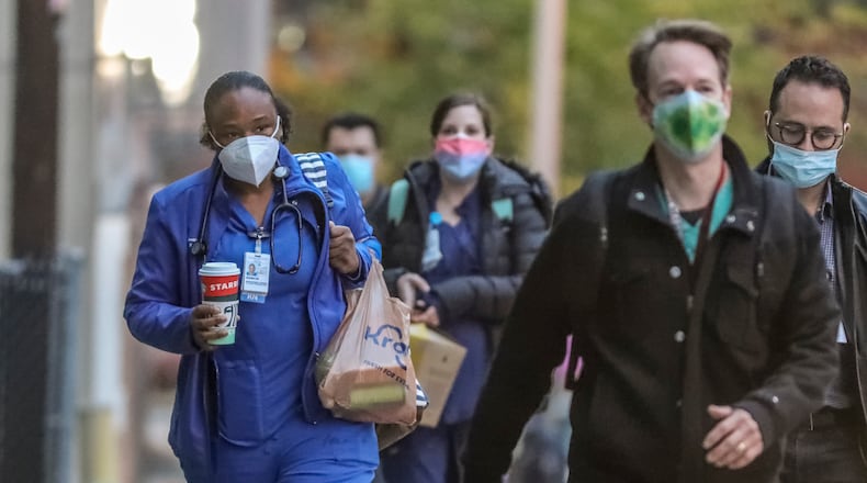 December 4, 2020 Atlanta: Medical workers arrive for work at Grady Memorial Hospital in Atlanta on Friday morning, Dec. 4, 2020 as major hospitals including Grady Memorial, WellStar Kennestone, Emory University and Augusta University were going on and off diversion last week, meaning ambulances bringing in more patients had to be turned away. On Thursday afternoon the Georgia Coordinating Council had 17 Georgia hospital emergency departments marked as overcrowded, six of them classified as “severe.” The predicted dark winter of the pandemic hasn’t even started, yet some Georgia hospitals are already running out of room for patients. That leaves Georgia in a dangerous position before the expected surge of coronavirus infections from Thanksgiving gatherings hits. (John Spink / John.Spink@ajc.com)