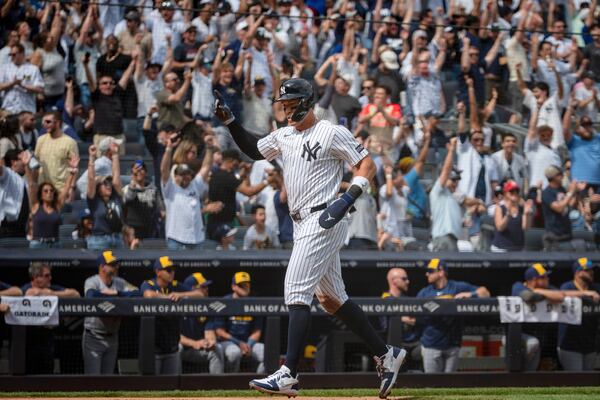 New York Yankees' Aaron Judge (99) heads home after hitting a grand slam in the third inning of a baseball game against the Milwaukee Brewers, Saturday, March 29, 2025, in New York. (AP Photo/Angelina Katsanis)