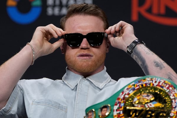 Canelo Alvarez adjusts his glasses during a news conference Friday, June 27, 2025, in Las Vegas. (AP Photo/John Locher)