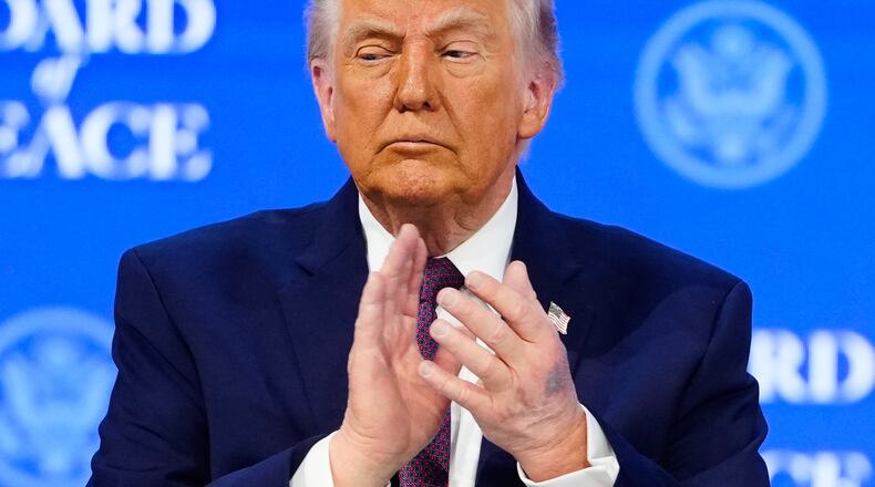 President Donald Trump applauses during a signing ceremony on his Board of Peace initiative at the Annual Meeting of the World Economic Forum in Davos, Switzerland, Thursday, Jan. 22, 2026. (AP Photo/Markus Schreiber)