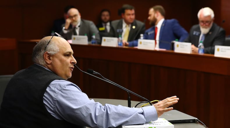 032822 Atlanta: Joel Natt, Forsyth County Board of Election Vice Chairman, sets a ream of 500 sheets of paper on the desk to make a point while addressing Georgia senators as they hear from the public and county election directors about their concerns with a sweeping voting bill that increases police powers and ballot inspections at the Coverdell Legislative Office Building on Monday, March 28, 2022, in Atlanta. Natt was opposed to having poll workers count blank paper used for ballots that had not been cast yet.    “Curtis Compton / Curtis.Compton@ajc.com”