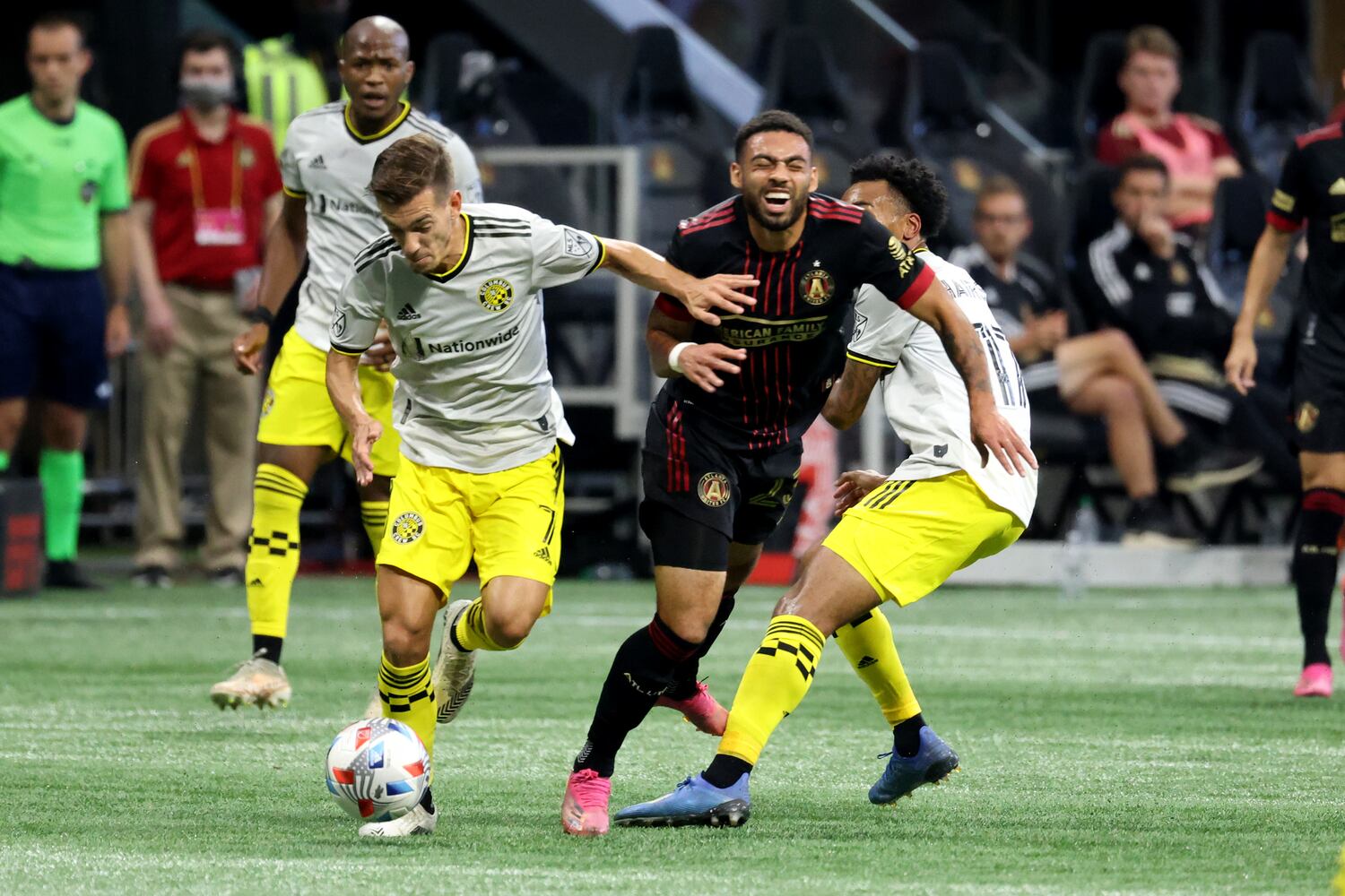 Atlanta United midfielder Jake Mulraney (23) is fouled on the play by Columbus Crew forward Pedro Santos (7, left) and midfielder Marlon Hairston (17). JASON GETZ FOR THE ATLANTA JOURNAL-CONSTITUTION